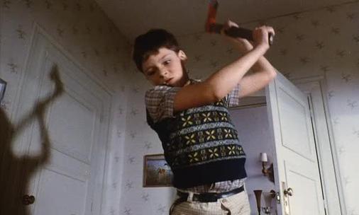 Still from the movie Pieces
A child holding an axe.